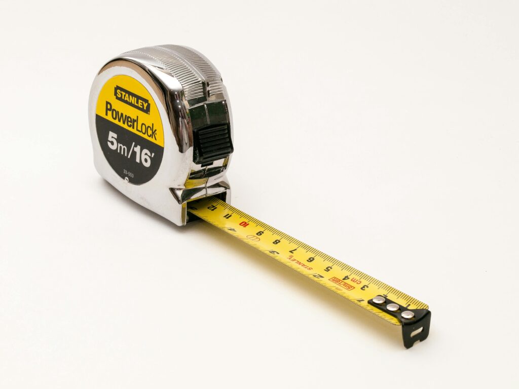 A close-up photograph of a Stanley PowerLock 5m/16ft measuring tape on a white background.