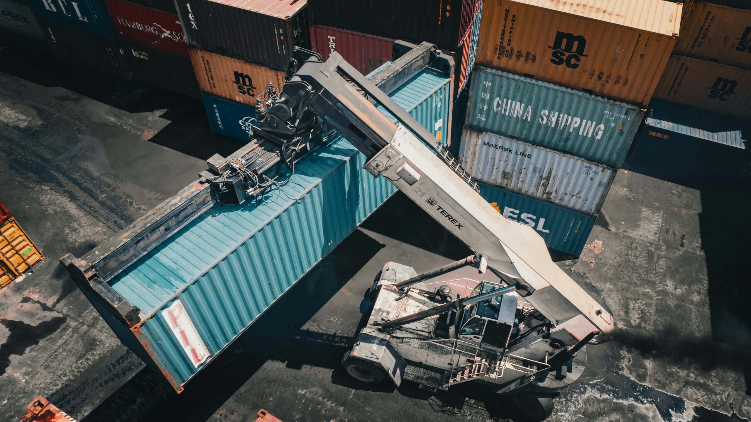 Aerial view of container handling in Dar es Salaam port showcasing industrial logistics.